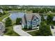 A blue home from above, with a lake and surrounding homes in a developed community at 13895 Cloverfield Cir, Fishers, IN 46038