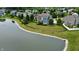 Aerial view of a backyard featuring a fence, lush lawn, landscaping, trees and a pond at 13895 Cloverfield Cir, Fishers, IN 46038