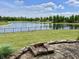 Backyard area featuring an attractive stone patio and a tranquil pond with mature trees at 13895 Cloverfield Cir, Fishers, IN 46038