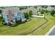 Aerial view of a spacious backyard with a patio, landscaping, and serene pond at 13895 Cloverfield Cir, Fishers, IN 46038