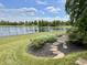 Landscaped backyard featuring a tranquil pond and stone accents for outdoor enjoyment at 13895 Cloverfield Cir, Fishers, IN 46038