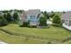 Spacious, well-maintained backyard with a black fence, lush lawn, and serene pond at 13895 Cloverfield Cir, Fishers, IN 46038