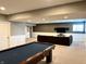 Finished basement with pool table, sectional couch, and wall-mounted TV at 13895 Cloverfield Cir, Fishers, IN 46038