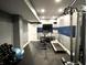 Finished basement gym with exercise equipment, television, and plenty of space for workouts at 13895 Cloverfield Cir, Fishers, IN 46038