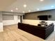 Finished basement with sectional couch and wall-mounted TV at 13895 Cloverfield Cir, Fishers, IN 46038