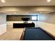 Finished basement with pool table, sectional couch, and wall-mounted TV at 13895 Cloverfield Cir, Fishers, IN 46038