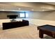Finished basement with pool table, sectional couch, and wall-mounted TV at 13895 Cloverfield Cir, Fishers, IN 46038