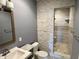 Stylish bathroom showcasing tiled walls, glass shower, modern fixtures, and sink with vanity at 13895 Cloverfield Cir, Fishers, IN 46038