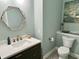 Modern powder room featuring gold accents, a modern vanity, and a decorative wall mirror at 13895 Cloverfield Cir, Fishers, IN 46038
