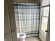 This bathroom includes a walk in shower, toilet, and a bright window at 13895 Cloverfield Cir, Fishers, IN 46038