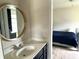 Bathroom sink with round mirror and black cabinets with bedroom view at 13895 Cloverfield Cir, Fishers, IN 46038