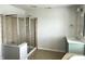 Bathroom featuring a shower with glass door, single sink, and decorative mirror at 13895 Cloverfield Cir, Fishers, IN 46038