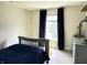 Bedroom featuring a bed, window with curtains, and a dresser with decorations at 13895 Cloverfield Cir, Fishers, IN 46038