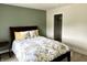 This bedroom includes a full sized bed, an olive green accent wall and a closet with a door at 13895 Cloverfield Cir, Fishers, IN 46038