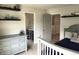 Bedroom with toys on shelves, view of bathroom, and a chest of drawers at 13895 Cloverfield Cir, Fishers, IN 46038