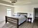 Bedroom featuring hardwood floors, tray ceiling, and side tables with lamps at 13895 Cloverfield Cir, Fishers, IN 46038