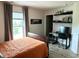 This bedroom has a desk/workspace, a comfortable bed, and natural light at 13895 Cloverfield Cir, Fishers, IN 46038