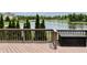 Deck with a chest overlooking the lake and manicured backyard at 13895 Cloverfield Cir, Fishers, IN 46038