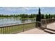 Large wooden deck offering picturesque views of the lake and lush backyard landscaping at 13895 Cloverfield Cir, Fishers, IN 46038
