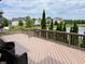 Spacious wooden deck overlooking a serene lake and manicured backyard at 13895 Cloverfield Cir, Fishers, IN 46038
