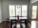 Dining room featuring a rustic wooden table, modern lighting, and large windows at 13895 Cloverfield Cir, Fishers, IN 46038