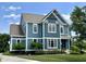 Charming two-story home with blue siding, white trim, and a well-manicured lawn at 13895 Cloverfield Cir, Fishers, IN 46038