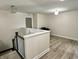 Hallway with chandelier lighting, neutral walls, wood floors, and a piano at 13895 Cloverfield Cir, Fishers, IN 46038