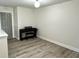 Hallway with an upright piano, wood floors, and a gray painted entry door at 13895 Cloverfield Cir, Fishers, IN 46038