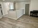 Hallway with hardwood flooring and neutral walls featuring an upright piano at 13895 Cloverfield Cir, Fishers, IN 46038