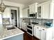 Bright kitchen featuring modern appliances, white cabinetry, a double oven, and a mosaic tile backsplash at 13895 Cloverfield Cir, Fishers, IN 46038