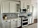 Well-appointed kitchen featuring stainless steel appliances and white cabinetry at 13895 Cloverfield Cir, Fishers, IN 46038