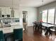 Open floor plan kitchen and dining area with island, modern appliances, and bright lighting at 13895 Cloverfield Cir, Fishers, IN 46038