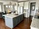 Kitchen featuring island with seating, granite countertops, stainless appliances, and modern fixtures at 13895 Cloverfield Cir, Fishers, IN 46038