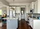 Bright kitchen featuring an island with seating, modern appliances, and stylish white cabinetry at 13895 Cloverfield Cir, Fishers, IN 46038