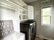 Laundry room featuring modern appliances, built-in shelving, and a window for natural light at 13895 Cloverfield Cir, Fishers, IN 46038