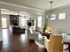 Open concept living room with fireplace, gray sectional, light gray walls, and hardwood flooring at 13895 Cloverfield Cir, Fishers, IN 46038
