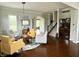 Bright living room featuring a seating arrangement, staircase, hardwood floors, and lots of natural light at 13895 Cloverfield Cir, Fishers, IN 46038