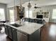Spacious living room with view of the kitchen island and open concept layout at 13895 Cloverfield Cir, Fishers, IN 46038