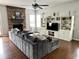 Beautiful living room featuring a fireplace, TV, and gray sofa with hardwood floors and light walls at 13895 Cloverfield Cir, Fishers, IN 46038