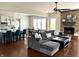 Inviting living room with a stone fireplace and view of the kitchen and dining area at 13895 Cloverfield Cir, Fishers, IN 46038