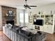 Comfortable living room features a stone fireplace and custom built-in shelving at 13895 Cloverfield Cir, Fishers, IN 46038