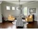 Comfortable living room area with an arrangement of yellow and gray seating. Features hardwood floors and light walls at 13895 Cloverfield Cir, Fishers, IN 46038