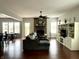 Open concept living room and dining area with lots of natural light. Hardwood floors, light walls and gray sofa at 13895 Cloverfield Cir, Fishers, IN 46038