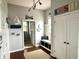 Coastal-themed mudroom featuring a bench with storage, nautical decor, and hardwood floors at 13895 Cloverfield Cir, Fishers, IN 46038