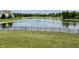 Scenic view of a serene pond from the property's well-manicured backyard at 13895 Cloverfield Cir, Fishers, IN 46038