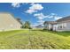 A large green backyard provides ample space between neighboring properties at 1396 Lexington Trl, Greenfield, IN 46140