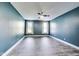 Spacious bedroom with gray floors, a ceiling fan, and two large windows at 1396 Lexington Trl, Greenfield, IN 46140