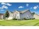 Side view of the house showcasing a well-maintained lawn and the home's siding at 1396 Lexington Trl, Greenfield, IN 46140