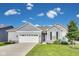 Charming single-story home with a manicured lawn, attached garage, and inviting front entrance at 1396 Lexington Trl, Greenfield, IN 46140