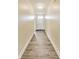 Inviting hallway with wood-look flooring leading to the front door at 1396 Lexington Trl, Greenfield, IN 46140